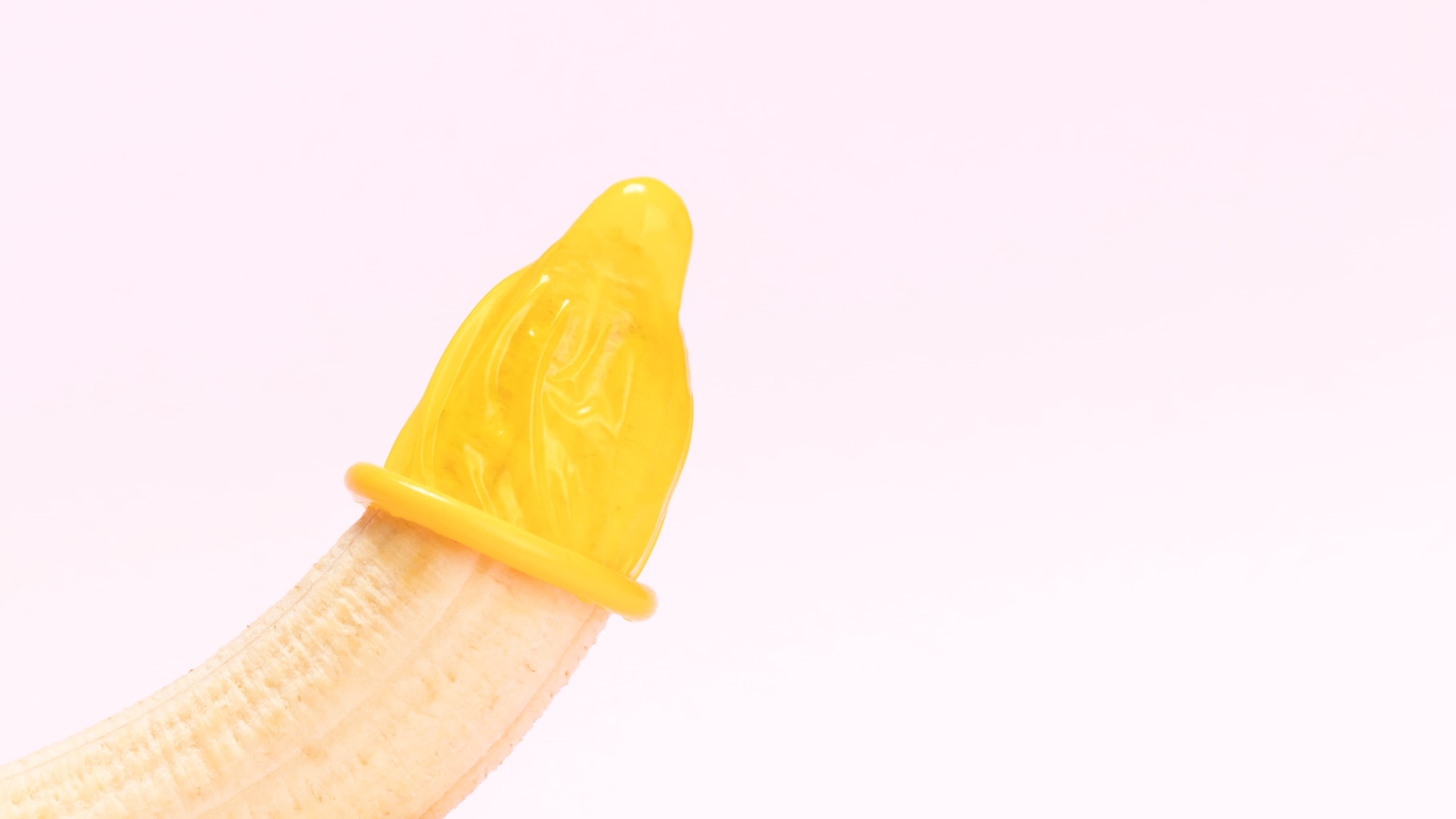A condom placed on a banana as a barrier protection demonstration.